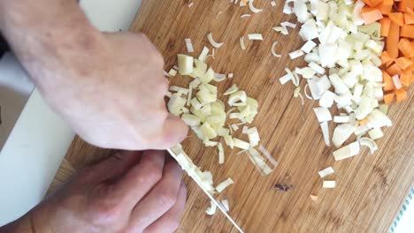 Overhead-view-of-chef-chopping-vegetables-finely