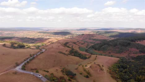 aerial view of a mountainous landscape with a winding road