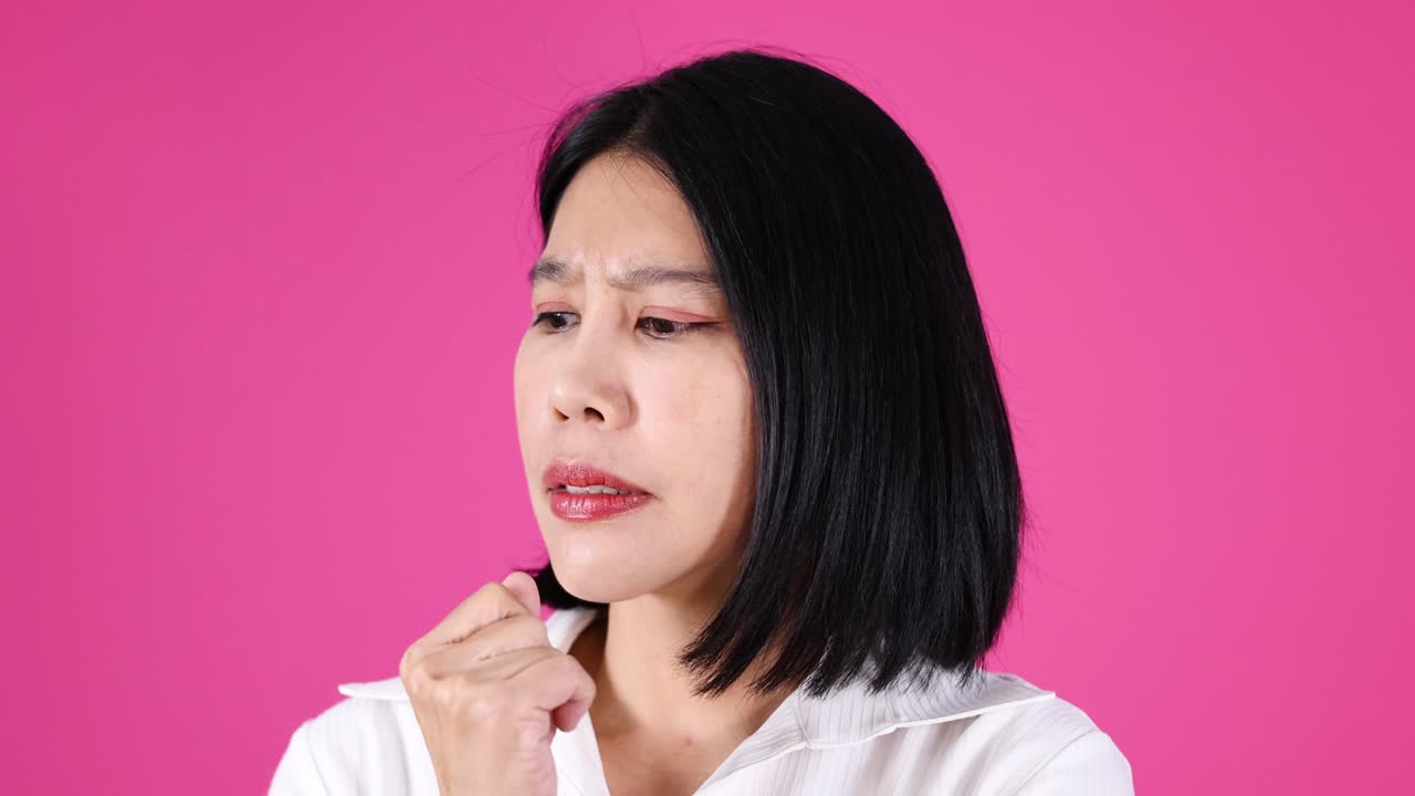 Asian woman in white shirt shows pensive, confused expressions under bright studio lighting, static camera