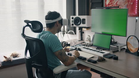 music producer explores virtual reality while seated in high-tech audio production studio
