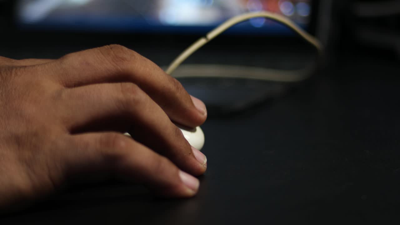 close up of mouse and hand with bokeh background