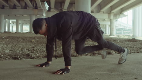 man doing street workout in city