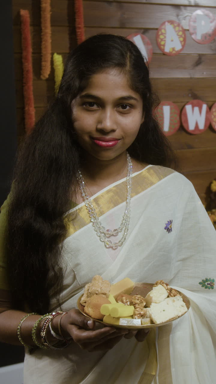 Woman celebrating Diwali with traditional dress and sweets