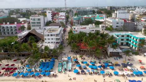 revealing drone shot of coastal town of playa del carmen revealing the ocean and resorts