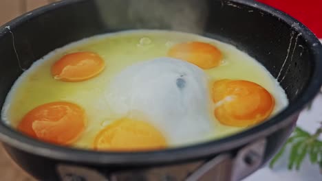 frying eggs with large air bubble in center, yolks vibrant and unbroken