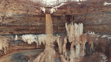 frozen waterfall cascading down a cliff face in winter