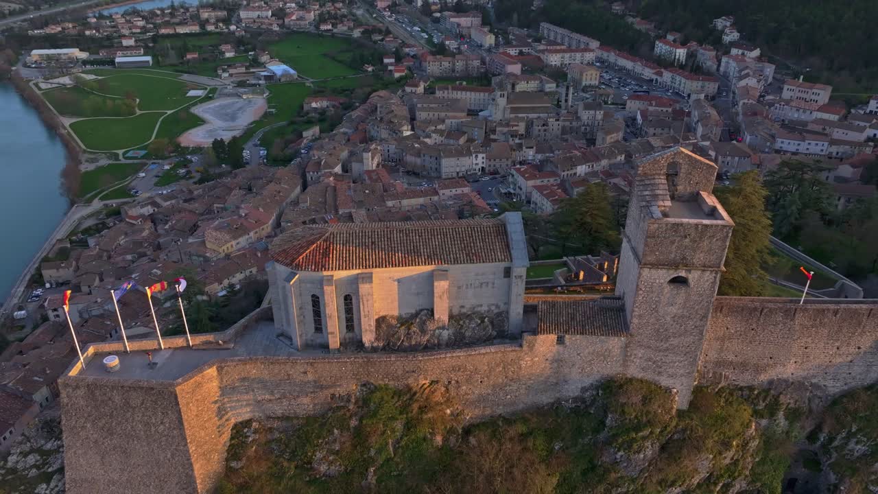 Warm light hits ancient citadel above French town at day's end