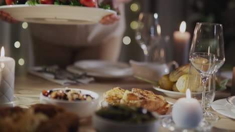 a woman puts a festive turkey on the table. thanksgiving celebration