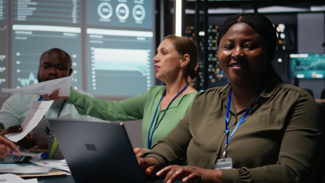 Portrait of african american advisor uses laptop in a night meeting
