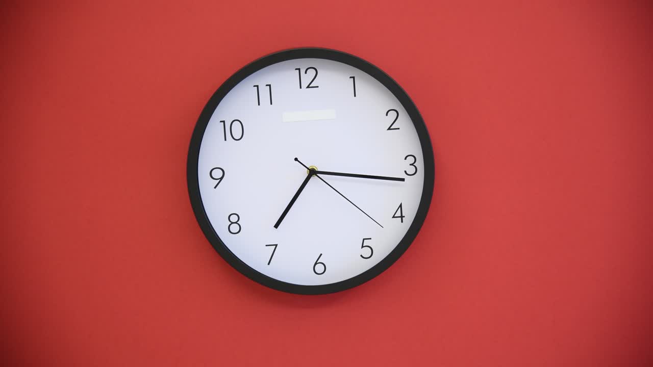 Black wall clock on red background
