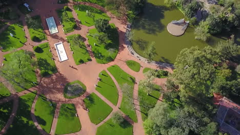 aerial - paseo el rosedal park in palermo, buenos aires, argentina, top down forward