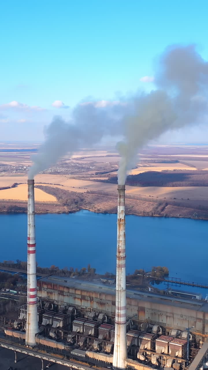Environmental global warming atmosphere. Aerial view of factory polluted ecology. Full length view Vertical video