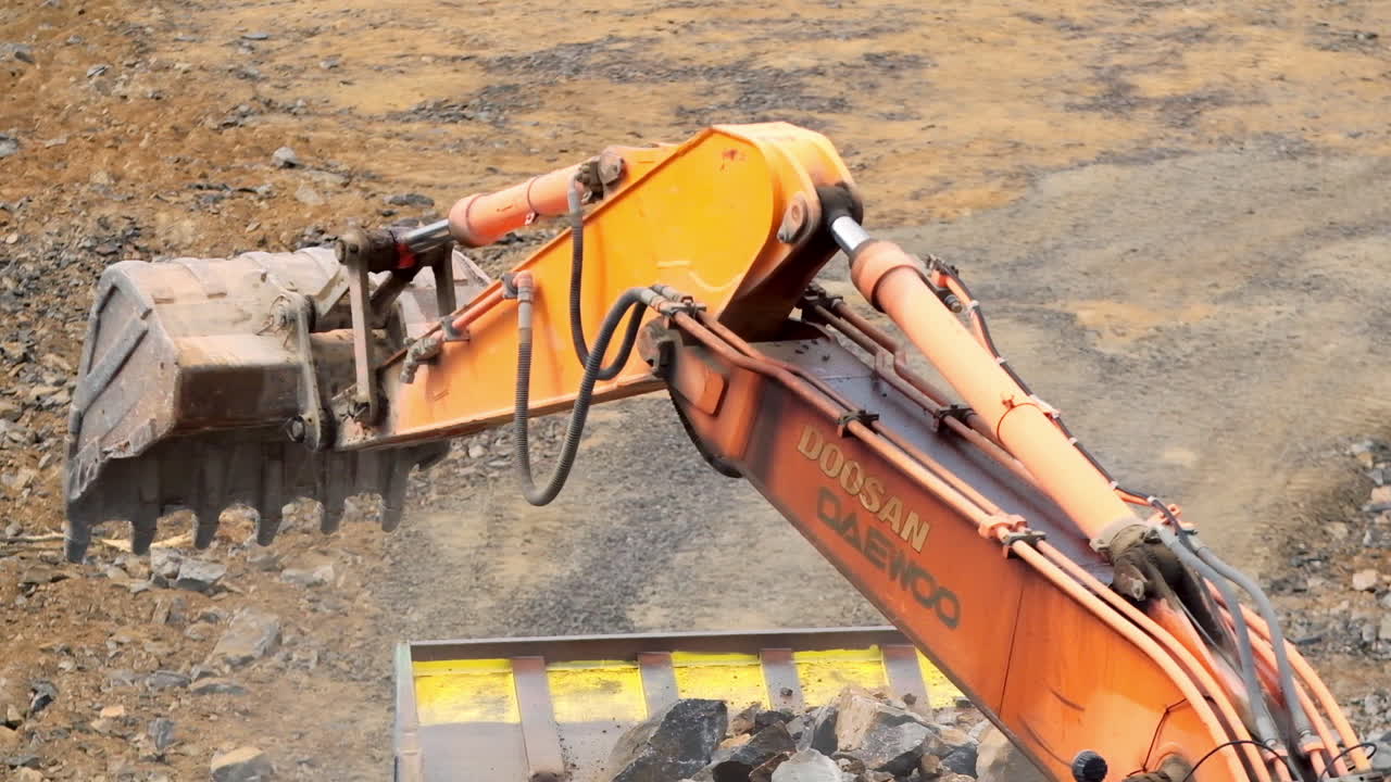 Industrial machinery on quarry site. Excavator and machinery at outdoor mine