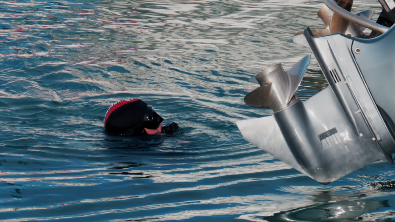 Woman in black equipment diving in the sea in Antibes, France