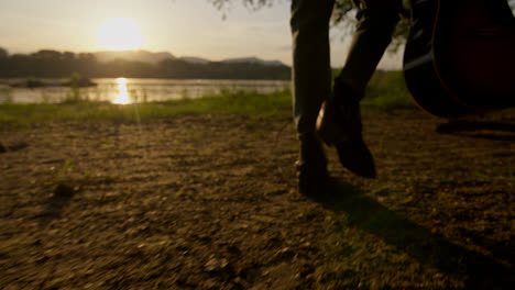 sunset river walk with guitar