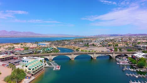 Drone-flying-towards-the-London-Bridge-in-Lake-Havasu-City,-Arizona