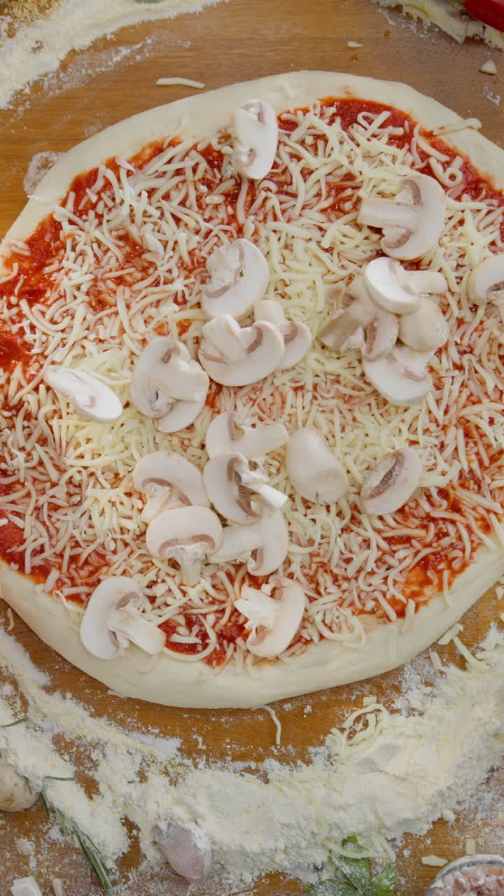 Making pizza with mushrooms and cheese