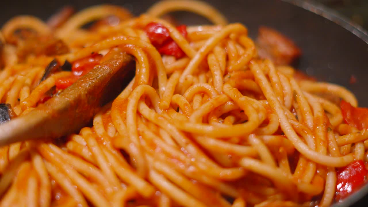 Moving Shot Over Italian Tomato Based Pasta Bucatini Spaghetti with Aubergine Egg Plant and Peppers. Delicious Cooking Close Up Food Clip