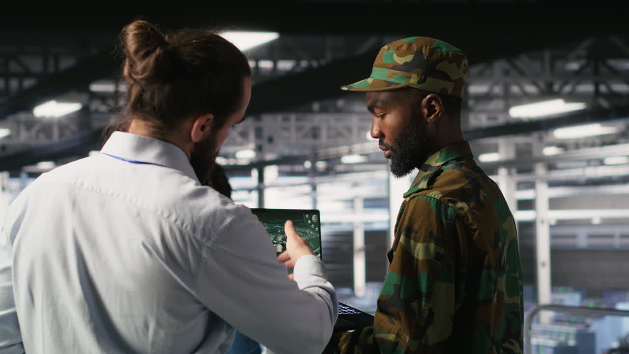 Army operators in data center using laptop to run drone control software