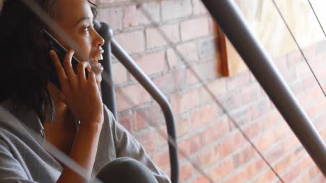 woman talking on mobile phone on stair 4k