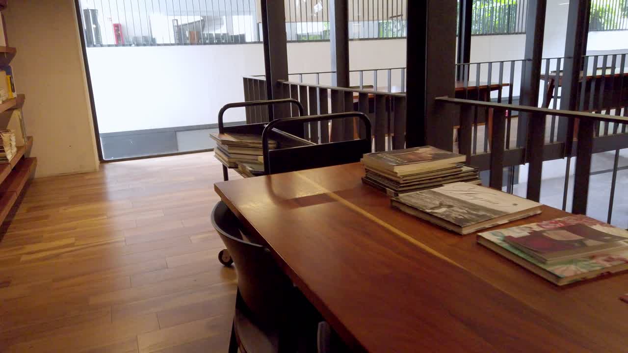 Close up of a reading table with books and chairs inside the library at Museo de Arte Moderno in Cuernavaca