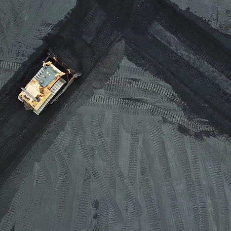 crawler bulldozer sorts coal into a thermal power plant. industry. aerial view.
