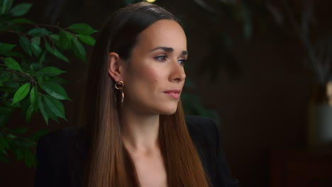 Businesswoman-thinking-in-office-interior.-Serious-woman-looking-at-camera