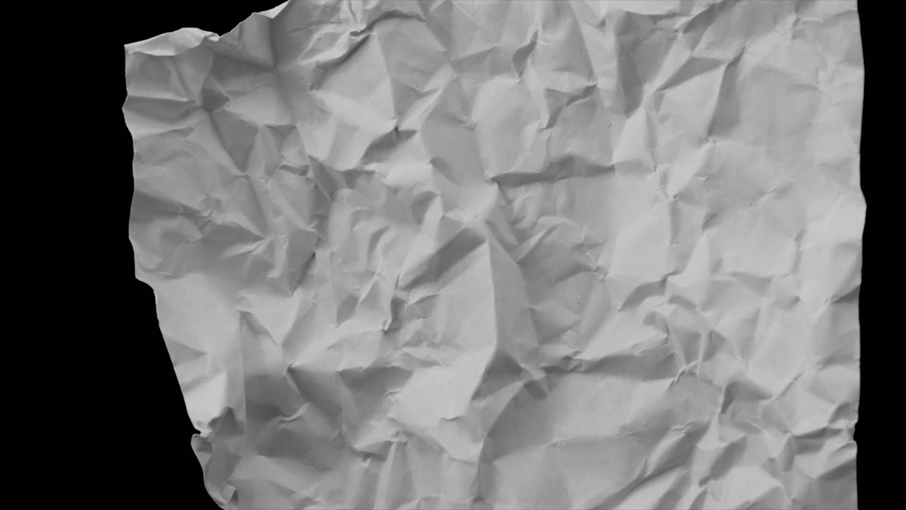 Crumpled White Paper Unfolding and Flattening on Black Background