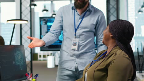 pleased startup office manager applauding female programmer for optimizing code