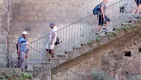 tourists ascending outdoor stairs in sorrento, italy