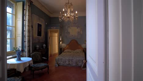 slow revealing shot of an antique master bedroom within a olden chateau