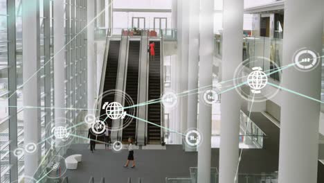 red de iconos digitales contra la vista desde arriba de la oficina moderna