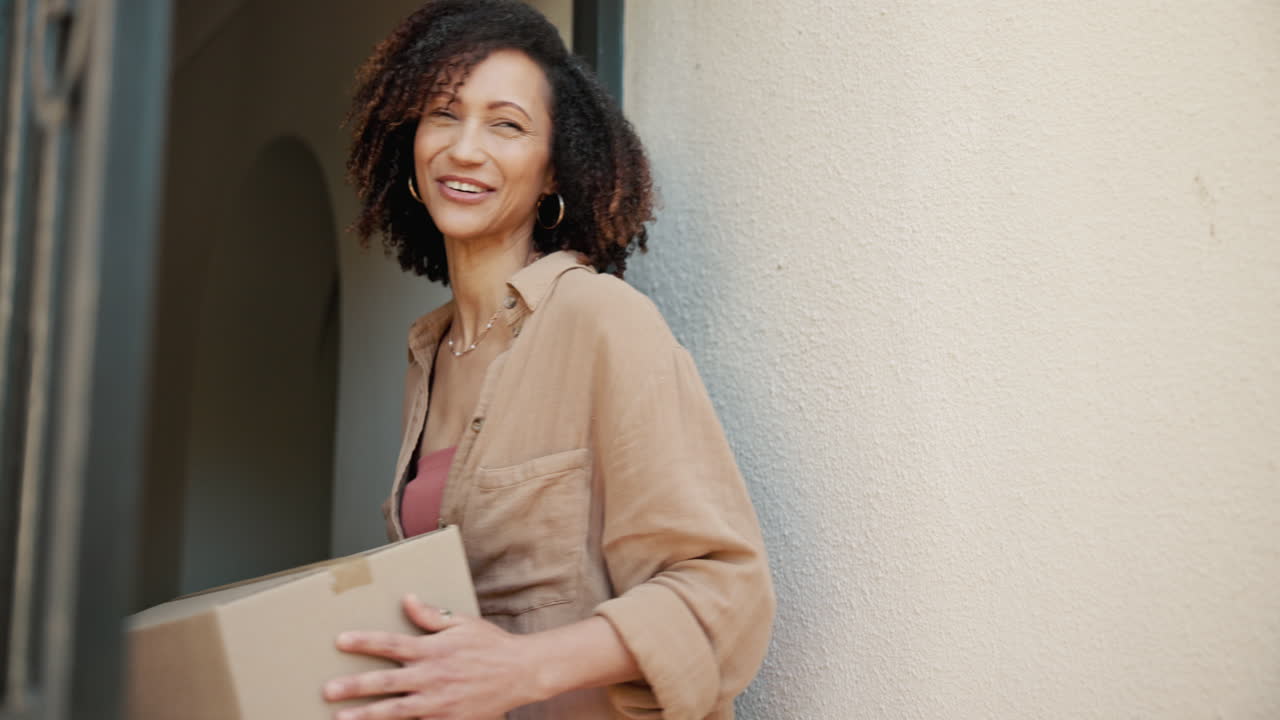 una mujer recibe un paquete de un repartidor