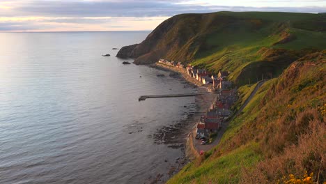 a small scottish coastal fishing village at sunset