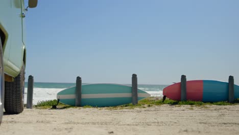 van and surfboard on the beach 4k