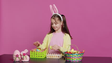 Smiling-happy-schoolgirl-presenting-a-handmade-decorated-basket-in-studio