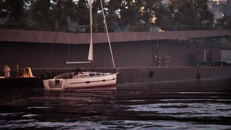 a sailboat docked at a marina in the city