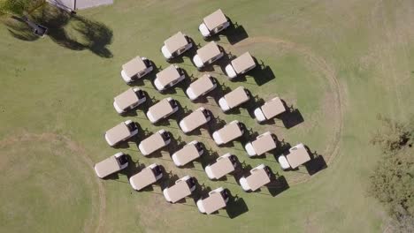 symmetrical, group formation of golf carts, top down rotating aerial view