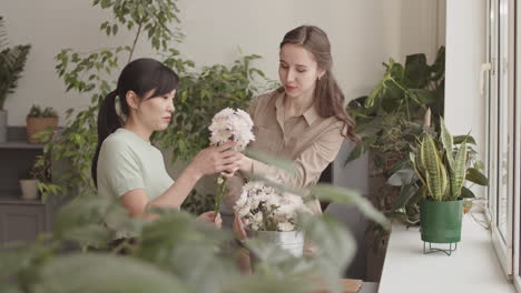 manager training employee in flower shop