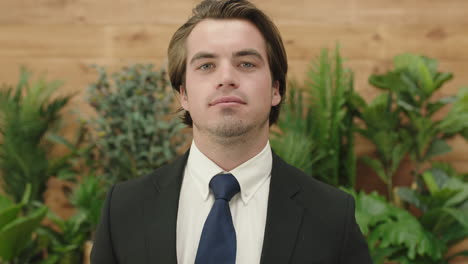 attractive young business man portrait of successful sales person wearing suit smiling confident at camera