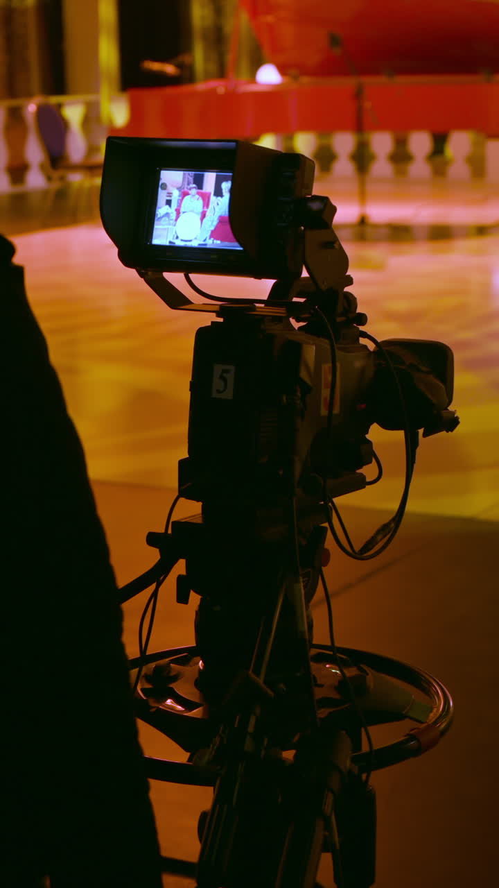 Professional camera filming on the backstage of a TV set. Vertical