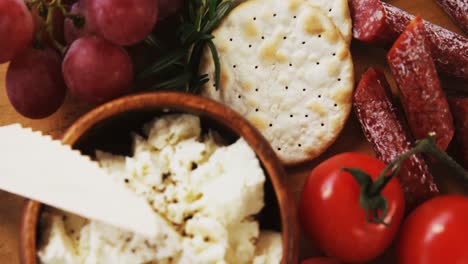 Crispy-biscuits,-tomatoes,-grapes-and-bowl-of-cheese