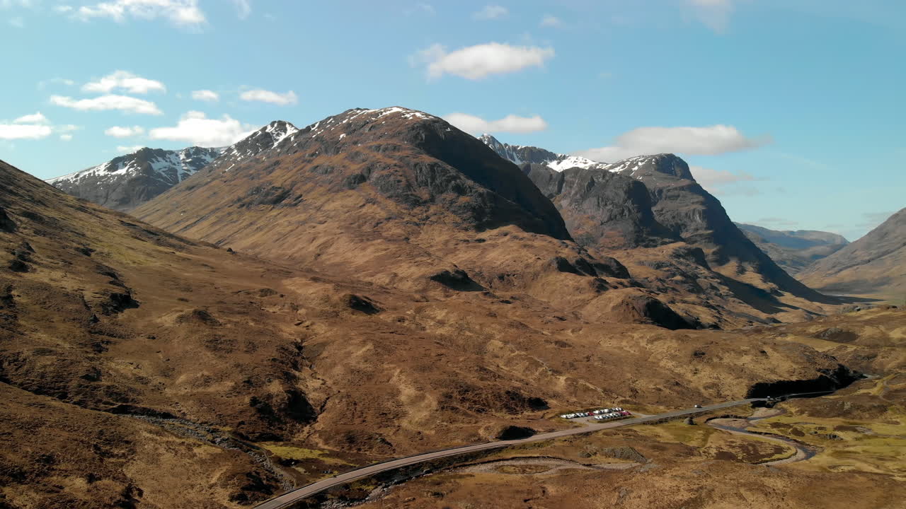 Drone shot of The Three Sisters Mountains in Glencoe, Scotland