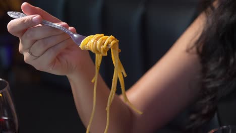 Slow-motion-of-fork-scooping-spaghetti-served-on-white-plate