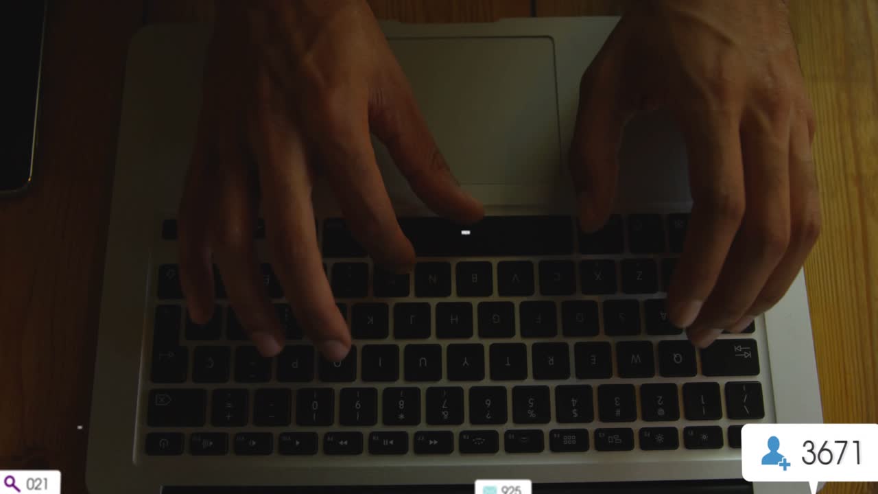 Male hands typing on laptop keys causing pop up icons clustering for rising engagement stats fading