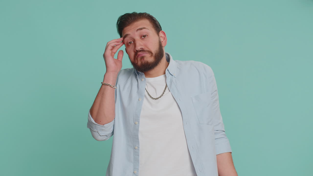 Puzzled clueless uncertain man raising hands in helpless, embarrassed confused by difficult question