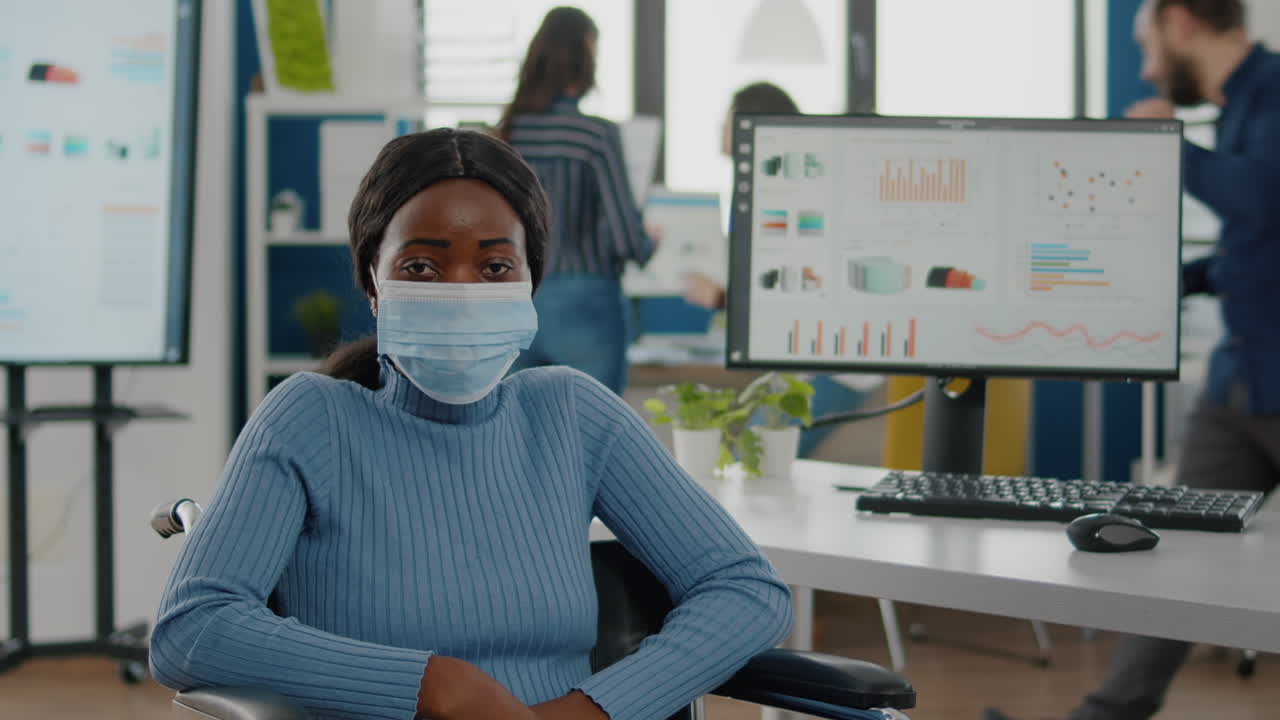 Portrait of african woman with protection face mask looking at camera