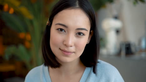 beautiful young female looks directly into the camera and smiles