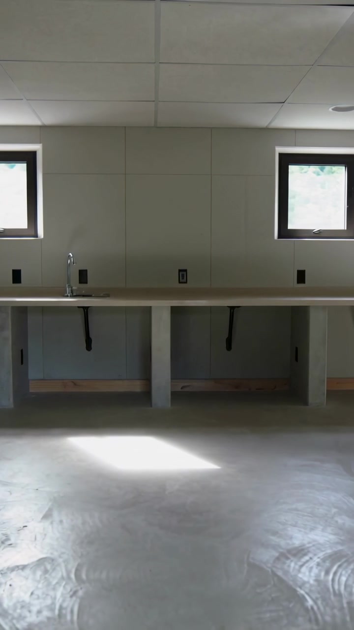 Vertical video: Shifting sunlight patch moving across utility room floor, showing sink and plumbing