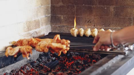 cooking mushrooms on grill. cook puts some skewers with chicken meat on charcoal. preparing the barbeque on the restaurant kitchen.